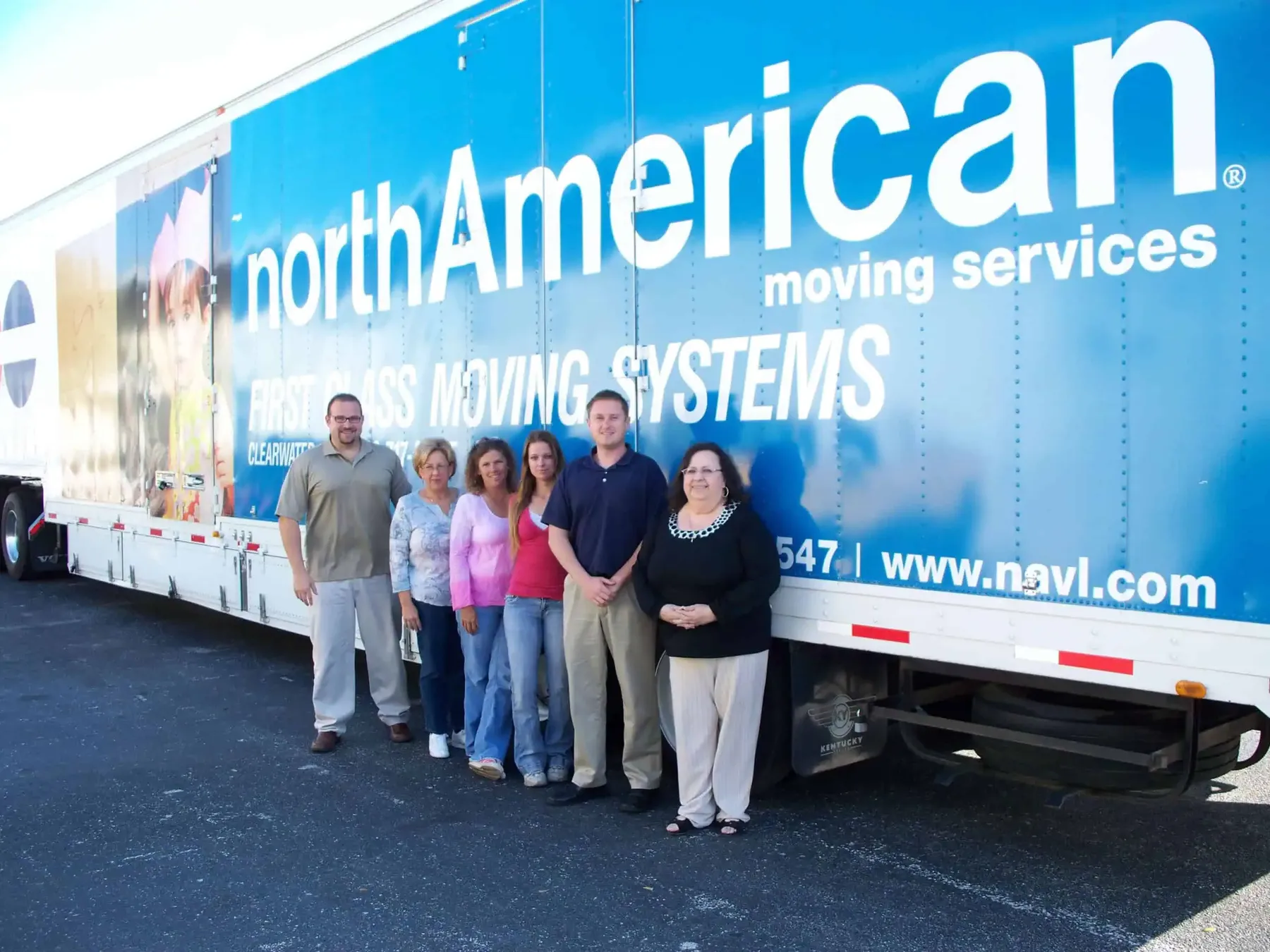 First Class Moving Systems staff posing in front of the company truck